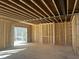Open-concept living room with exposed beams and view to backyard, ready for customization at 211 Meadow Walk Dr, Fuquay Varina, NC 27526