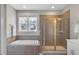 A bathroom featuring a soaking tub, a shower with glass doors, and a large window at 2540 Glade Mill Ct, Fuquay Varina, NC 27526