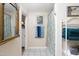 Bathroom featuring a tiled floor, a decorative mirror and a shower with a stylish curtain at 2606 W Knox St, Durham, NC 27705