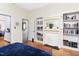 Cozy bedroom featuring built-in bookshelves, creating a warm and inviting space for relaxation at 2606 W Knox St, Durham, NC 27705