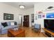 Inviting living room featuring hardwood floors, a comfortable blue sofa, and classic decor at 2606 W Knox St, Durham, NC 27705