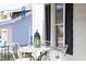 Inviting front porch features outdoor seating with decorative lantern and windchime detail at 2606 W Knox St, Durham, NC 27705