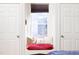 Relaxing window seat with decorative pillows nestled between two doors, offering a cozy retreat at 2606 W Knox St, Durham, NC 27705