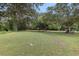 Expansive backyard features mature trees, lush green grass, and a serene landscape at 2732 Old Milburnie Rd, Raleigh, NC 27604