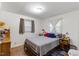 Cozy bedroom with hardwood floors, a comfortable bed, and natural light at 2732 Old Milburnie Rd, Raleigh, NC 27604