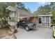 Carport shows parking, exterior brick, and access to front screened porch at 2732 Old Milburnie Rd, Raleigh, NC 27604