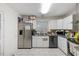 Functional kitchen featuring stainless steel refrigerator, white cabinets and granite countertops at 2732 Old Milburnie Rd, Raleigh, NC 27604