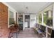 View of sunroom with vinyl floors, laundry and storage cabinets, open windows and access to backyard views at 2732 Old Milburnie Rd, Raleigh, NC 27604
