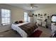 Bright bedroom with two windows, ceiling fan, and neutral carpet at 305 River Birch Run, Coats, NC 27521