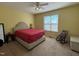 Bedroom featuring bright yellow walls, a plush bed, and a cozy rocking chair at 305 River Birch Run, Coats, NC 27521