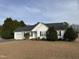 Charming home featuring a well-manicured front yard, attached garage, and welcoming entrance at 305 River Birch Run, Coats, NC 27521