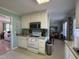 Open kitchen featuring white cabinets, a range, and an eating area at 305 River Birch Run, Coats, NC 27521