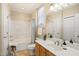 Bright bathroom featuring a tub/shower combo, single vanity, and warm neutral color palette at 401 Finsbury St # 301, Durham, NC 27713