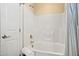 Clean white bathroom with tub/shower featuring tile surround, and classic fixtures at 401 Finsbury St # 301, Durham, NC 27713