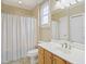 Bathroom featuring a shower with blue striped curtain and a light wood vanity at 401 Finsbury St # 301, Durham, NC 27713