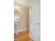 Powder room featuring pedestal sink, decorative mirror, and classic trim at 401 Finsbury St # 301, Durham, NC 27713