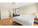 Spacious bedroom with hardwood floors, desk area, ensuite bathroom, and natural light at 401 Finsbury St # 301, Durham, NC 27713