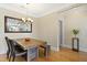 Dining area features a rustic wood table, stylish chandelier, and views of greenery at 401 Finsbury St # 301, Durham, NC 27713