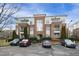 Brick condo building with parking in front under a bright sky at 401 Finsbury St # 301, Durham, NC 27713