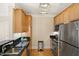 Galley kitchen boasts stainless steel appliances, black granite countertops, and wood cabinetry at 401 Finsbury St # 301, Durham, NC 27713