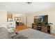 Open living area with a modern TV console and view to the dining area and kitchen at 401 Finsbury St # 301, Durham, NC 27713
