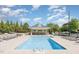 Inviting community pool featuring ample lounge chairs, nearby seating and covered area at 401 Finsbury St # 301, Durham, NC 27713