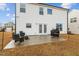 A home's backyard featuring a patio set, grill, and manicured lawn and a classic white siding at 456 Highview Dr, Benson, NC 27504