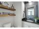 Stylish half-bathroom features floating wood shelves, a granite countertop, and modern fixtures at 456 Highview Dr, Benson, NC 27504