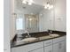 Bathroom featuring dual sinks, granite countertops, and walk-in shower at 456 Highview Dr, Benson, NC 27504