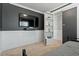 Stylish bedroom with a TV, gray accent wall, and a hidden bookshelf door to another room at 456 Highview Dr, Benson, NC 27504