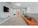 Spacious bonus room featuring soft modular sofas, a television, and great natural light at 456 Highview Dr, Benson, NC 27504