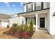 Inviting front porch with manicured landscaping and a black front door at 456 Highview Dr, Benson, NC 27504