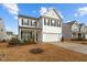Charming two-story home with a two car garage and landscaped front yard with nice blue skies at 456 Highview Dr, Benson, NC 27504