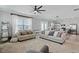 Spacious living room featuring neutral-toned furniture, a ceiling fan, and an open floor plan at 456 Highview Dr, Benson, NC 27504