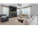 Cozy living room with a fireplace, large windows, comfortable seating, and a ceiling fan at 456 Highview Dr, Benson, NC 27504