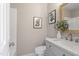 Neutral bathroom featuring a gray vanity, framed art, and modern fixtures at 4610 Lemon Heights Dr, Sanford, NC 27332