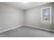 This bright bedroom features plush carpet, neutral paint, and ample natural light from the window at 4610 Lemon Heights Dr, Sanford, NC 27332