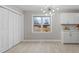 Bright dining area with an elegant chandelier, pantry, and open access to the kitchen at 4610 Lemon Heights Dr, Sanford, NC 27332