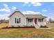 Inviting home featuring a classic front porch, well-kept lawn, and neutral siding at 4610 Lemon Heights Dr, Sanford, NC 27332
