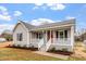 Charming home exterior with a cozy front porch and well-maintained landscaping at 4610 Lemon Heights Dr, Sanford, NC 27332