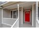 Charming front porch featuring a vibrant red door and classic architectural details at 4610 Lemon Heights Dr, Sanford, NC 27332