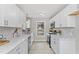 Bright and functional kitchen with white cabinets, modern countertops, and stainless steel appliances at 4610 Lemon Heights Dr, Sanford, NC 27332