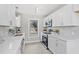 Bright kitchen with stainless steel appliances, white cabinets, and modern countertops at 4610 Lemon Heights Dr, Sanford, NC 27332