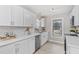 Modern kitchen featuring white cabinets, stainless steel appliances, quartz countertop and a window view at 4610 Lemon Heights Dr, Sanford, NC 27332