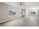Bright living room features wood-look floors, a ceiling fan, modern light fixture, and ample natural light at 4610 Lemon Heights Dr, Sanford, NC 27332