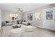 Inviting living room with comfortable seating, neutral colors, ceiling fan and ample natural light from a large window at 4610 Lemon Heights Dr, Sanford, NC 27332