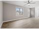 Bright living room features wood-look floors, a ceiling fan, and ample natural light from the windows and door at 4610 Lemon Heights Dr, Sanford, NC 27332