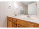 Double vanity bathroom with wooden cabinets and a large mirror, offering plenty of space at 4618 Pooh Corner Dr, Raleigh, NC 27616