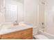 Bathroom with a single sink vanity with a tub and shower combination and a large mirror at 4618 Pooh Corner Dr, Raleigh, NC 27616