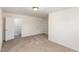 Bedroom featuring neutral carpet, built-in shelving, and ample closet space at 4618 Pooh Corner Dr, Raleigh, NC 27616